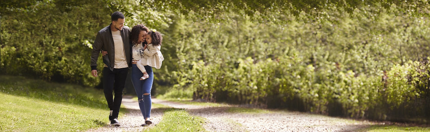 Young family walking in field