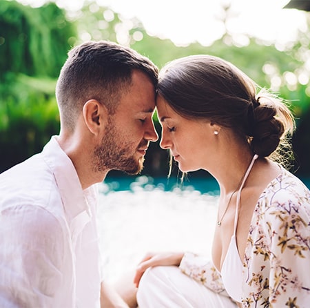 couple with foreheads together and eyes closed peacefully