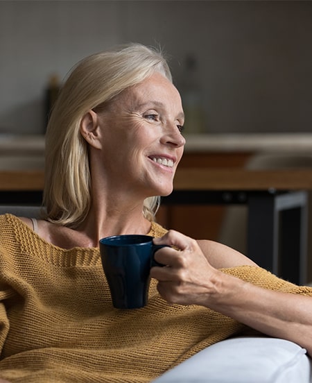 woman drinking coffee smiling