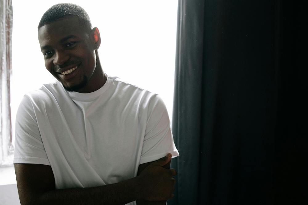 Man In Front Of Window Smiling
